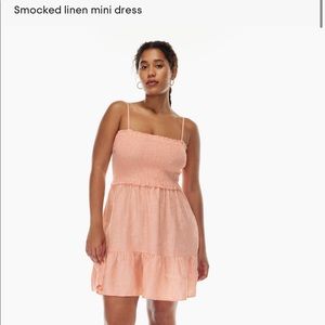 Tempest linen sleeveless mini dress. Smocked bodice. Tiered ruffled bottom.